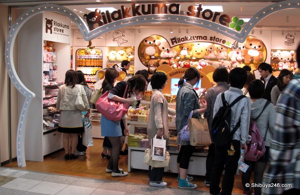 Plenty of people milling around the entrance to the store as well as inside