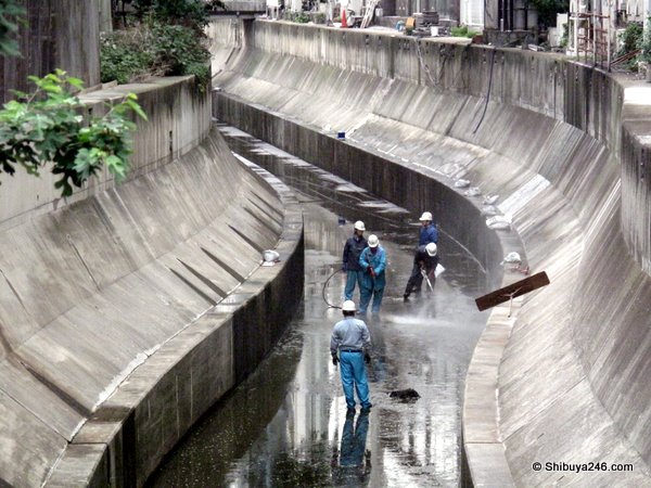 Hosing down the river bed