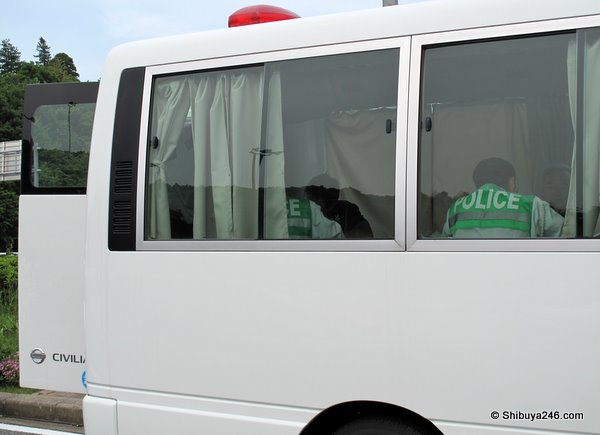 In the back of the paddy wagon. Looks comfortable though