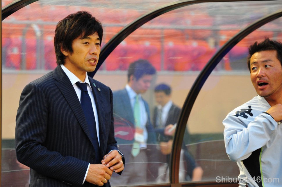 The manager and coach look on cautiously planning the next moves for their team
