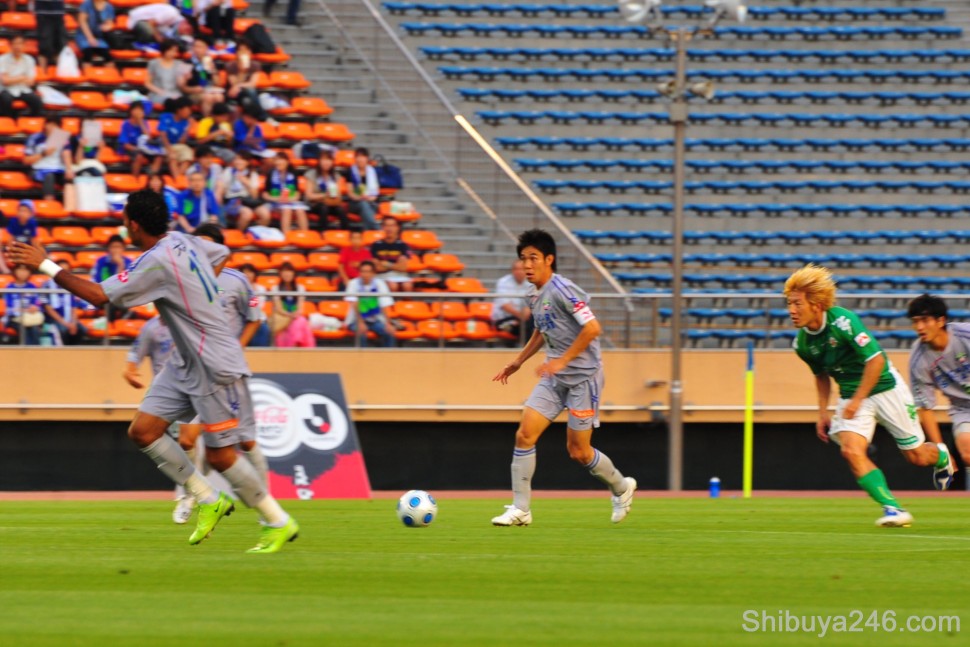 With the match underway, Tokushima Vortis in the gray strip make an attacking move