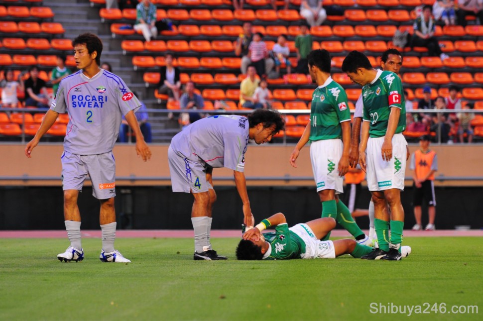 A Verdy player goes down after a hard tackle