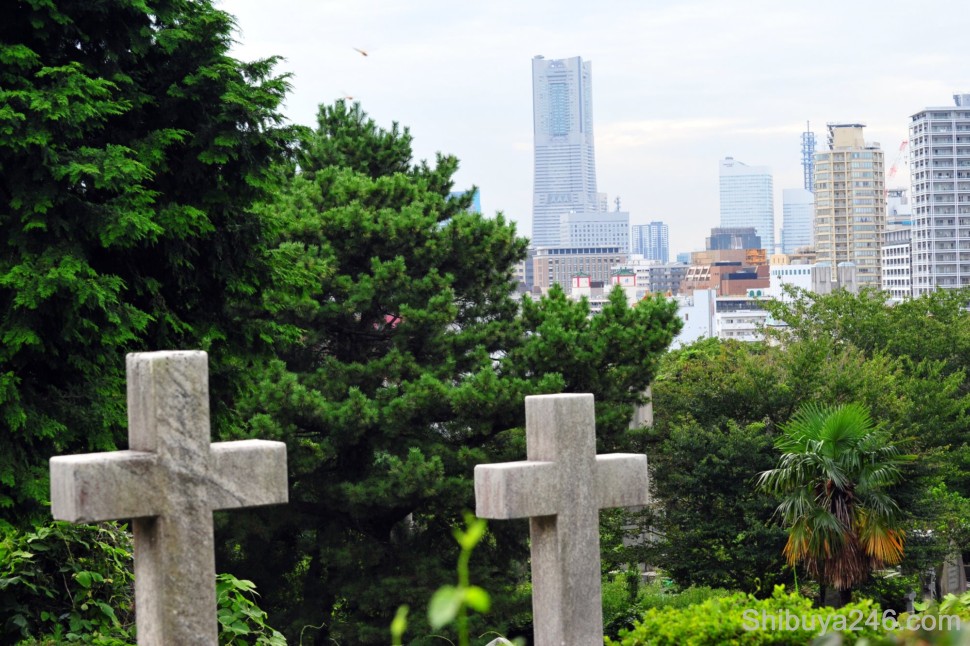 Gaijin Bochi, or Foreigners Cemetry dating back to mid 1800's, with The Landmark Tower in the background.