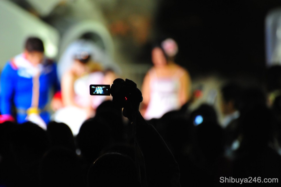 The area was packed and it was difficult to take photos. Here a video camera is held high to catch some footage