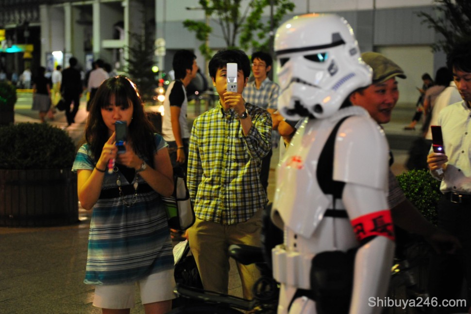 Mobile phones were the chosen weapon for most earthlings. The Stormtrooper kept his weapon holstered
