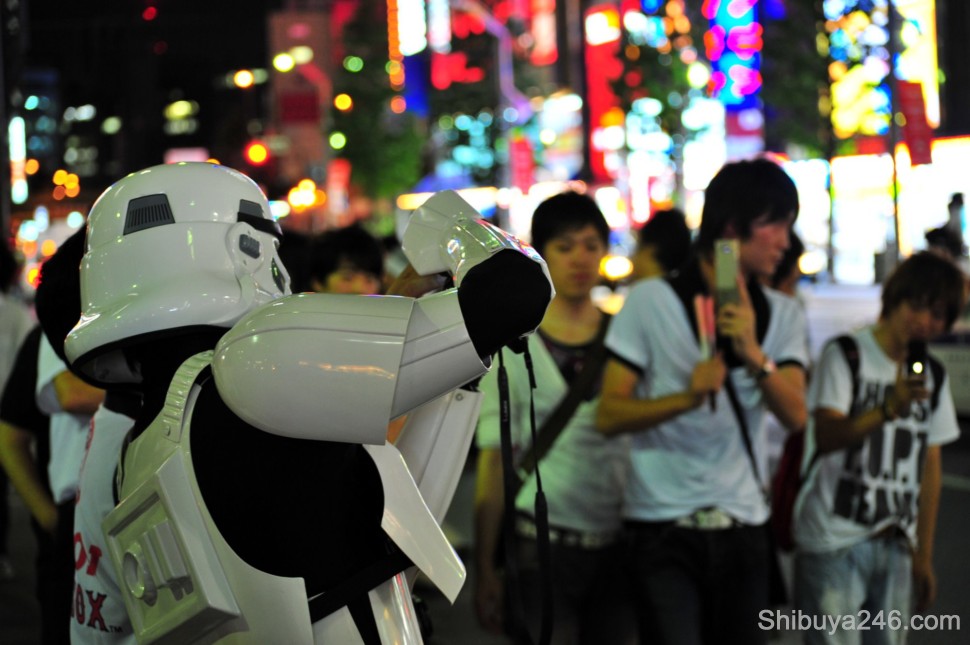 Those that are taken photos can quickly become the ones being taken. The stormtrooper fires off a few shots at the crowd