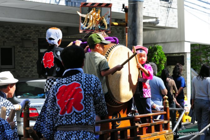 The kids beating the large drum