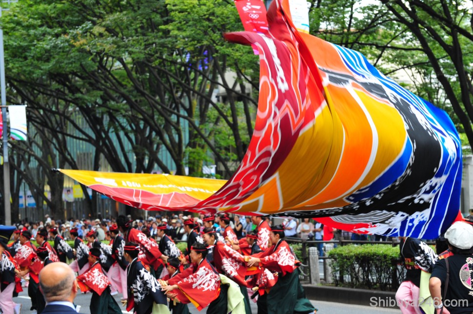 As the flag unfurls the performance goes on beneath it