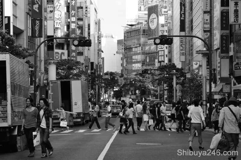 As the crowd clears the road gives way to the many shop signs, looking back here to Shibuya Station