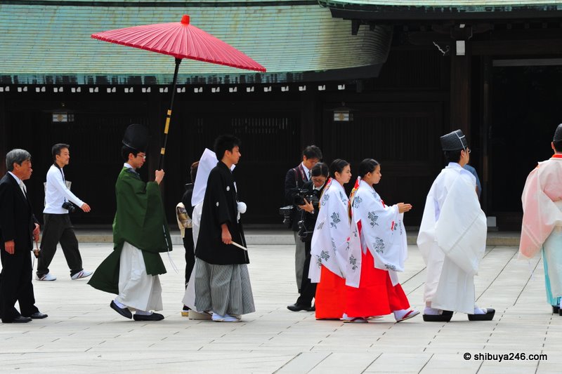 The wedding party passes through the courtyard