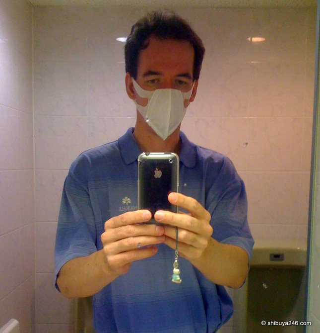 Waiting at the hospital with mask on, excuse the urinals in the background!