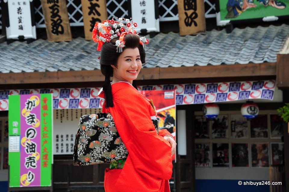 My niece wears a bright red kimono in this Kyoto Eigamura setting.