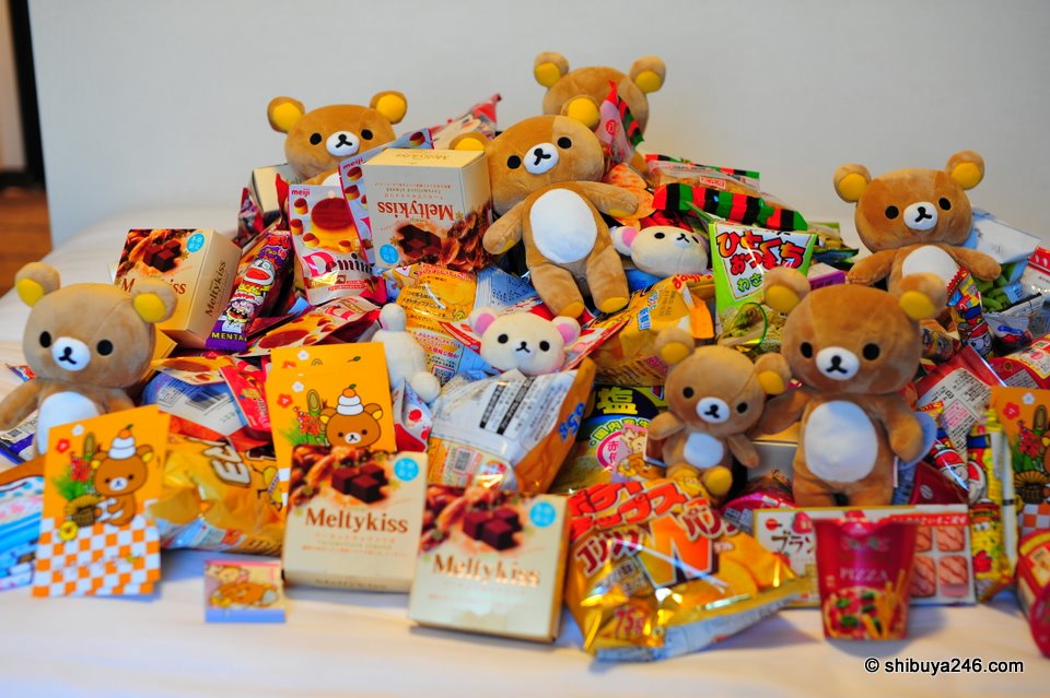 My bed is piled high with Rilakkumas and conbini goods