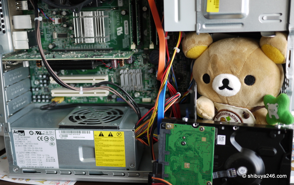 Rilakkuma helping fix my computer. He wanted to check the head room for the disk drive before we put in in.