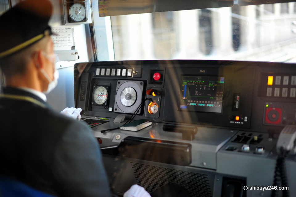 The driver cab of the Yamanote Line heading for Tokyo Station. Really like the place drivers have reserved for putting their pocket watches. When changing shift, they remove the pocket watch and the new driver puts his in the place. Nice touch of the old with new.