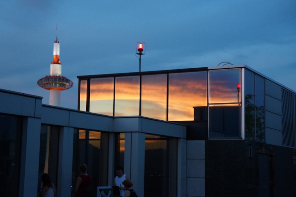 A quick view of Kyoto Tower with sunset reflected from buildings